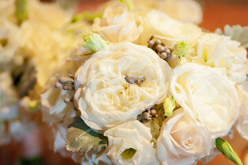 wedding rings on bridal bouquet