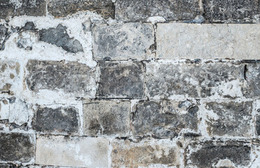 Old medieval brick gray wall