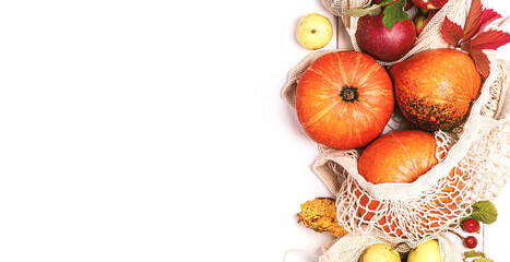 Naklejka na ściany i meble Autumn background with pumpkins and fruits. Pumpkins, apples and pears in shopping bags on a white background top view. Free space for text. Autumn shopping. Thanksgiving Day.
