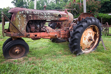 Obraz premium Old Rusty Tractor with flat tires. 