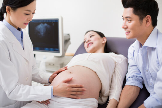 Pregnant woman ready to have fetal sonogram