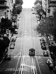 A lone cable-car begins its climb up California Street in San Francisco