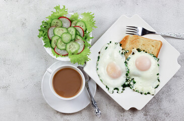 Breakfast - fried eggs with green onions, toast and fresh salad of radishes and cucumbers on a plate on a light gray background. Top view, flat lay