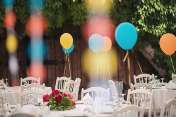 Holiday party decoration. The Colorful balloons attached to the table. Decorated balloons for birthday.