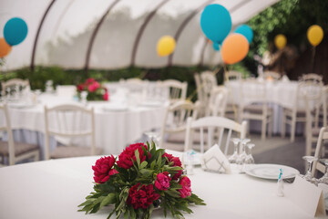 Holiday party decoration. The Colorful balloons attached to the table. Decorated balloons for birthday.