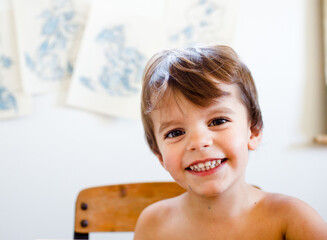 portrait of boy in front of blue coloring pages