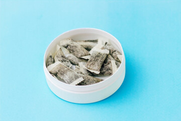 Round box with snus. Cigarette substitute, nicotine pouches.