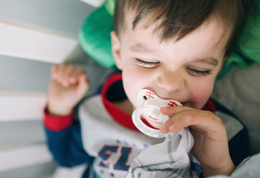 laughing toddlers with a pacifier