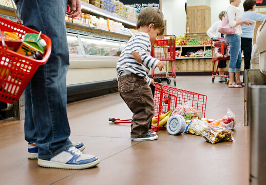 little boy spills grocery cart