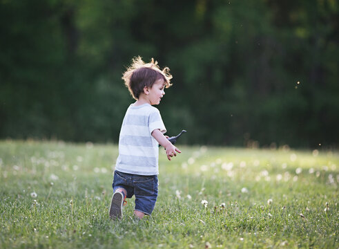 boy running through field