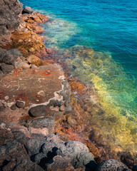 red rocks green sea water
