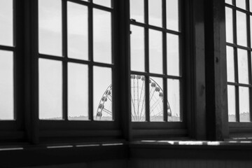 Fototapeta na wymiar Ferris wheel behind a window
