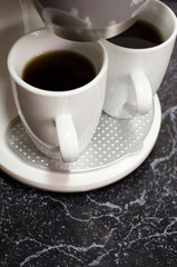 Two cups of coffee top view. Process of espresso making with usage of coffee machine. Kitchen appliance.