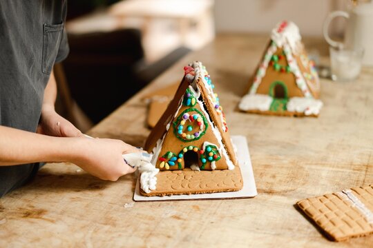 boy building and decorating a gingerbread house - Powered by Adobe