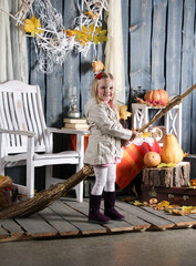 girl depicts a witch on a broomstick in Halloween decoration