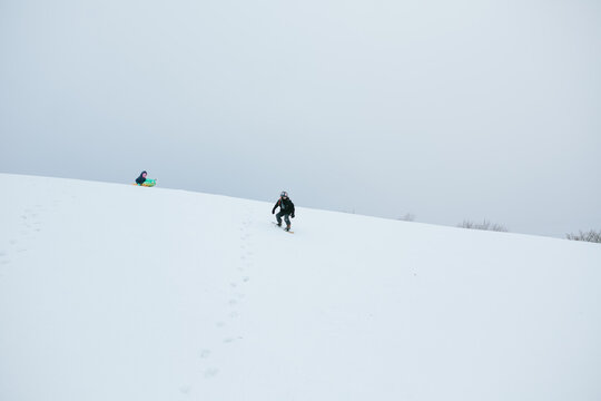child standing on top of snowy hill
