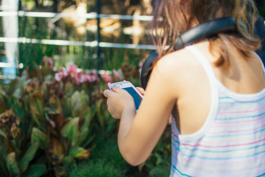 Young girl using a smart phone to take photos