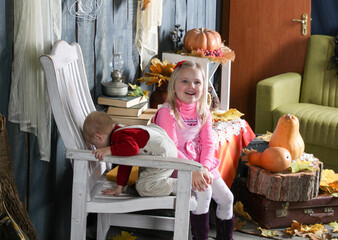 two sisters on a chair in halloween decorations