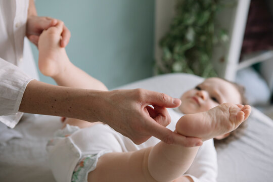 Professional Osteopath Working With Crawling Toddler Child
