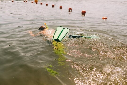 boy diving in water with mask