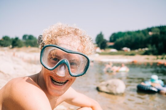 teen with a silly smile and goggle / diving mask