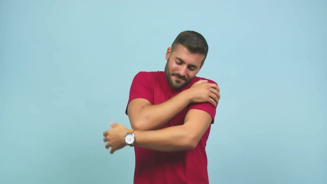 Young caucasian handsome man giving a hug, feeling of pride and happiness, affection towards yourself