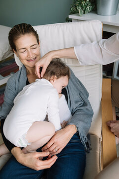 Professional Osteopath Working With Mother And Her Child