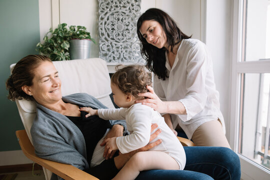Professional Osteopath Working With Mother And Her Child