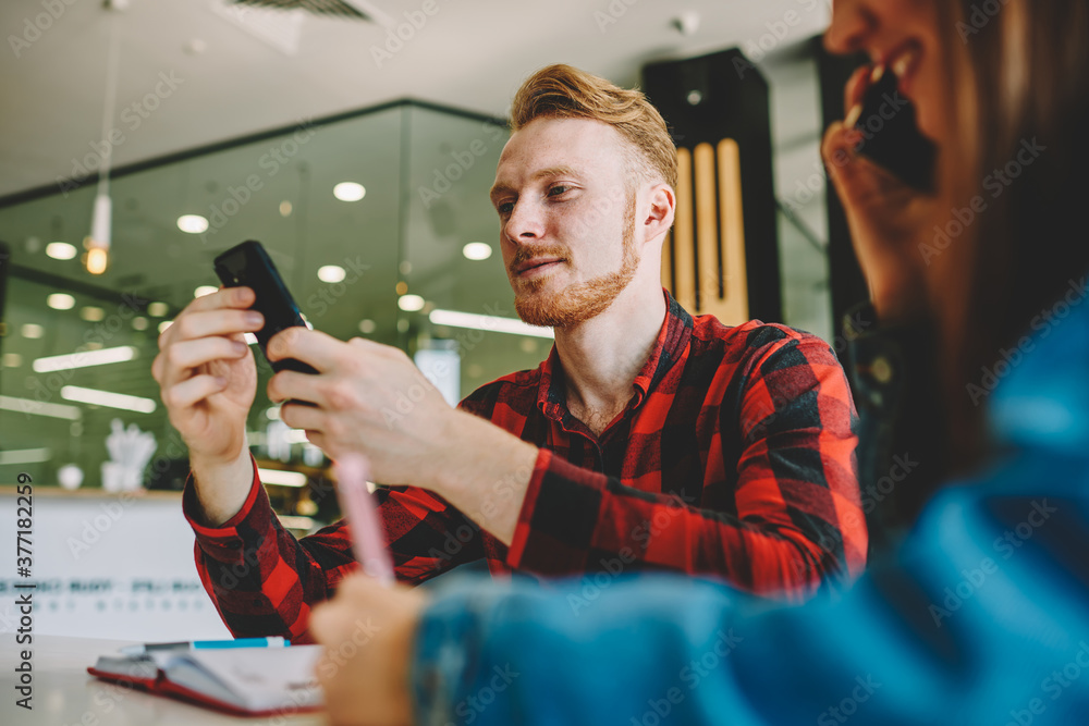 Poster blurred female student using cellular device for making mobile conversation during friendly meeting 