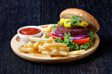 Beet burger with pickles, tomatoes and red onion