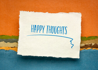 happy thoughts inspirational handwriting on a small sheet of white Khadi rag paper against colorful abstract landscape, positive mindset concept