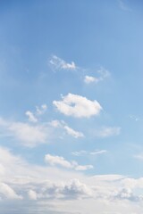 Fototapeta premium Light blue sky with delicate small clouds, sky background