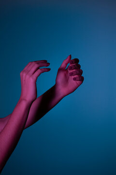Conceptual Photo: Female Hand In pink Light