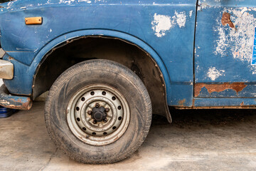 Antique front of pickup with crack and decay parked