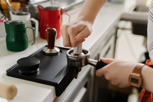 Young woman working at coffee bar