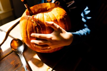 stock photo of boy carving a pumpkin