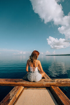 A Chinese female sitting on the boat with bikini