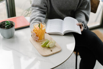 Young woman reading a book in a coffee shop