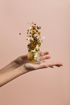 Girl Blowing Gold Star Confetti