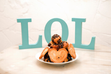 plate of sweets on marble table, (letters word LOL), Mediterranean house background