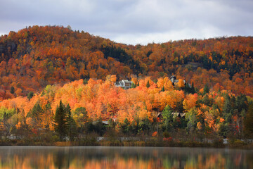 Vacation homes at Mont Tremblant village in Canada surrounded  with fall foliage
