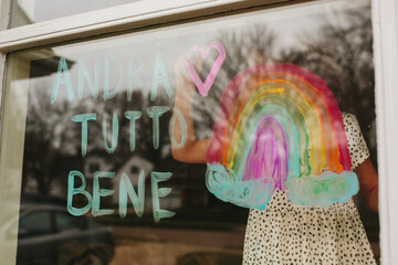 girl writes message on window