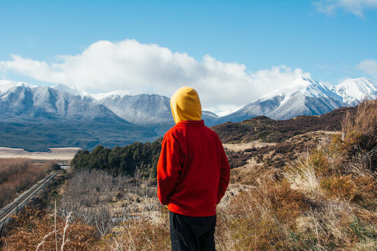 Man looking at snow capped mountains