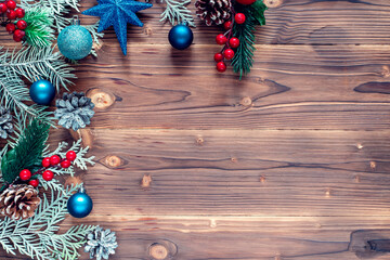 Christmas decoration with spruce branches with a red and blue ball. Winter holiday light decoration. Top view.