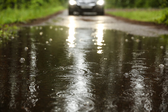 raindrops in a puddle on the road.
