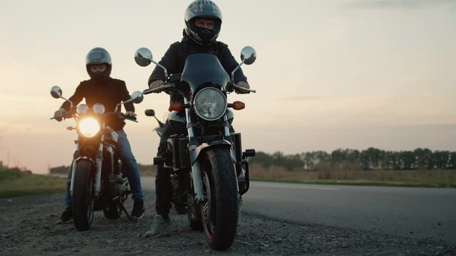 A group of bikers gets on motorcycles and starts the journey
