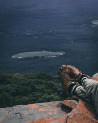 Feet of a man in the mountain with beautiful landscape