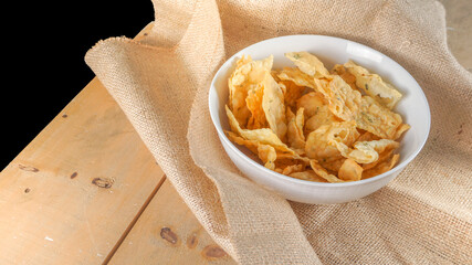 Crispy salty snacks on wooden background. close up shot