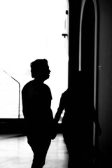 Couple silhouette walking inside a building