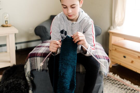 boy knitting a scarf